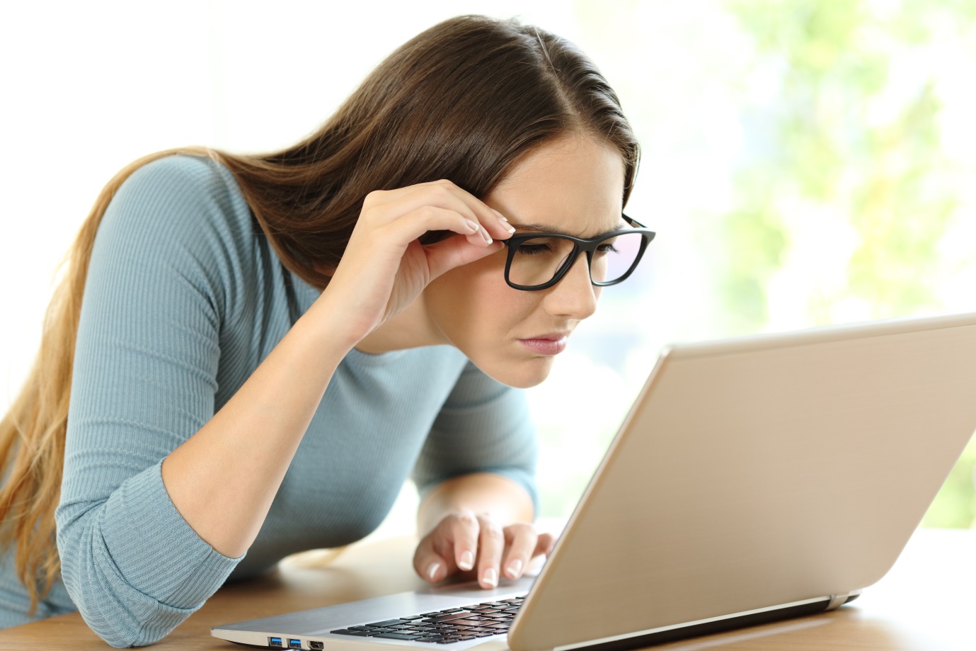 woman-with-eyesight-problems-trying-to-read-in-a-laptop-at-home
