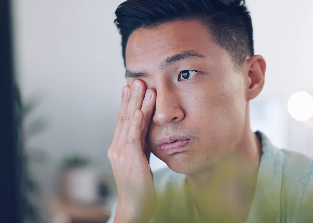Man rubbing his eye due to irritation, representing dry eye symptoms treated at Excel Laser Vision Institute in Los Angeles and Orange County